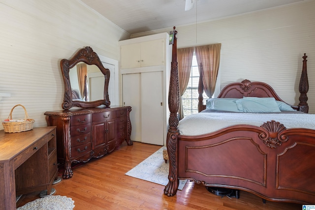 bedroom featuring ornamental molding, light wood-type flooring, and a closet