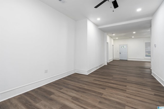 empty room featuring ceiling fan and dark hardwood / wood-style flooring