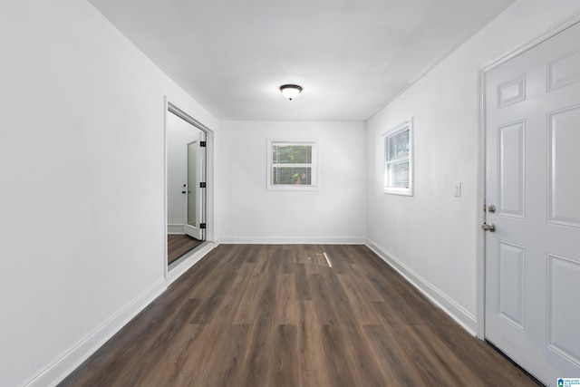 corridor with dark wood-type flooring