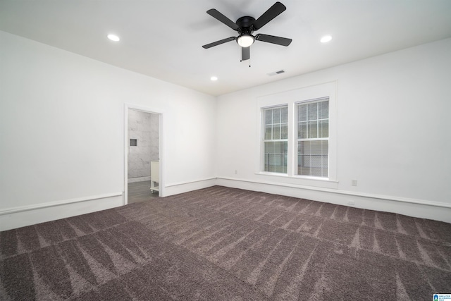 carpeted spare room featuring ceiling fan