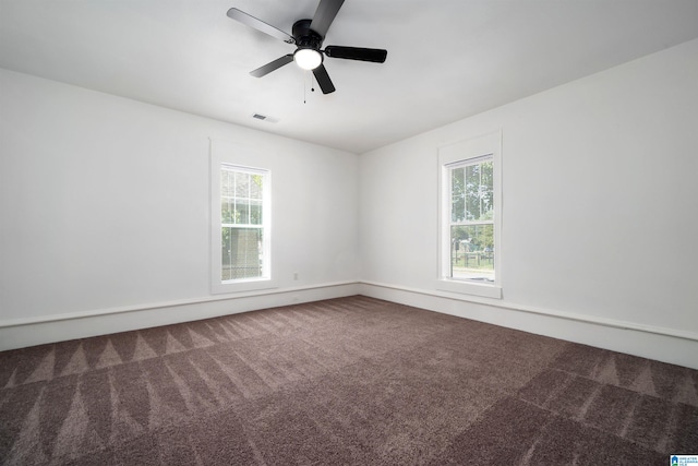 carpeted spare room with ceiling fan