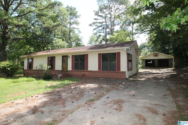 ranch-style house featuring a garage and an outbuilding