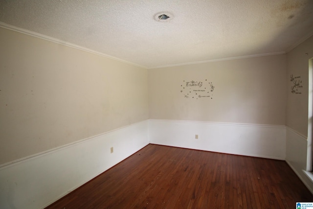 unfurnished room with dark wood-type flooring, a textured ceiling, and ornamental molding