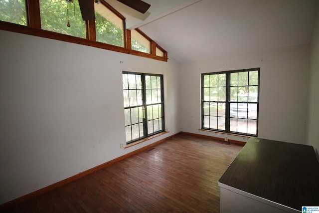 unfurnished living room with ceiling fan, hardwood / wood-style flooring, high vaulted ceiling, and beam ceiling