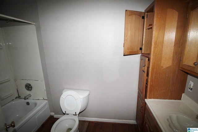 full bathroom with  shower combination, vanity, toilet, and hardwood / wood-style flooring