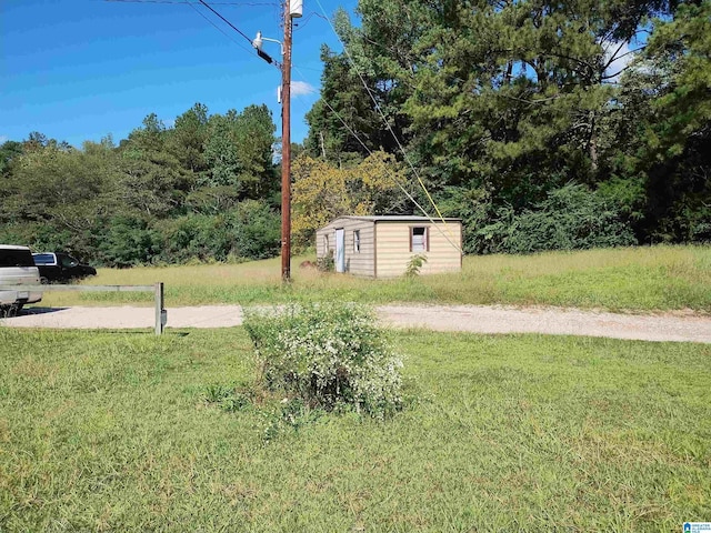 view of grassy yard with an outdoor structure and a storage shed