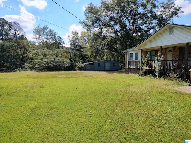 view of green lawn featuring an outbuilding