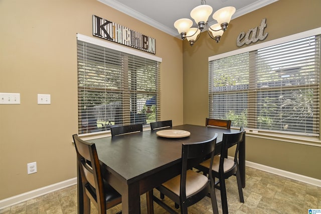 dining space with ornamental molding, a wealth of natural light, and a chandelier