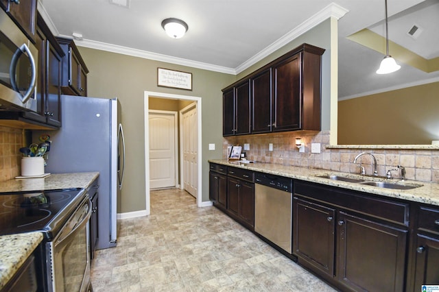 kitchen with pendant lighting, appliances with stainless steel finishes, backsplash, and sink