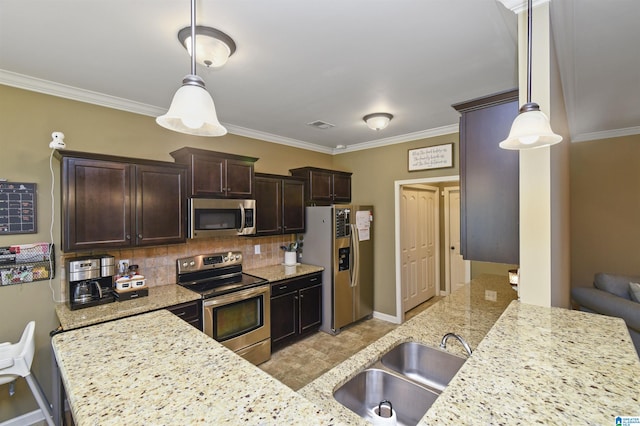 kitchen with appliances with stainless steel finishes, hanging light fixtures, backsplash, light stone countertops, and sink