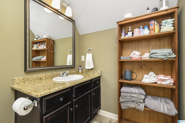 bathroom with vanity and vaulted ceiling