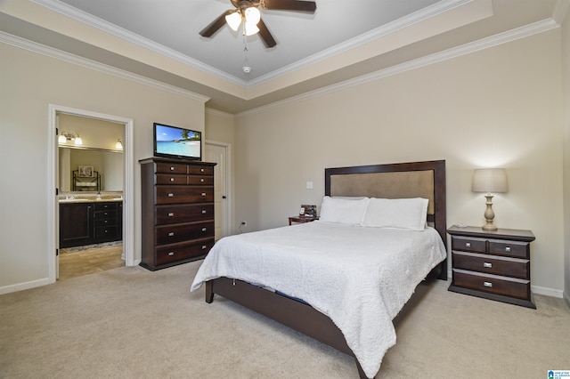 carpeted bedroom featuring crown molding, ceiling fan, ensuite bathroom, and a raised ceiling