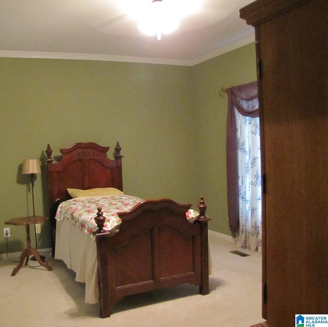 carpeted bedroom featuring ornamental molding