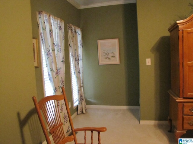 living area featuring crown molding and light colored carpet