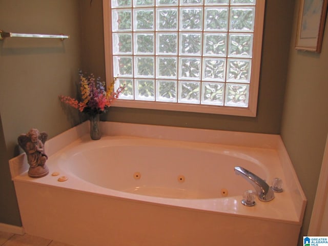 bathroom with a bathtub and tile patterned flooring