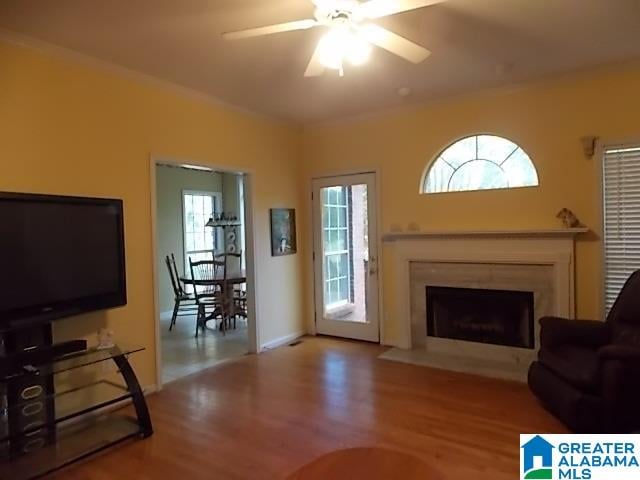 living room featuring wood-type flooring and ceiling fan