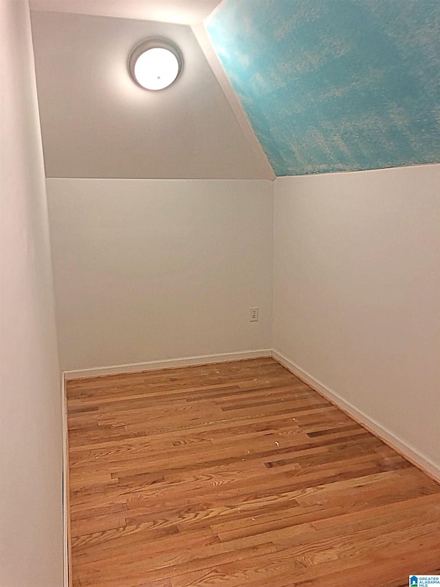 bonus room featuring light wood-type flooring and lofted ceiling