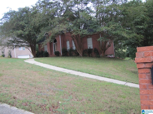 obstructed view of property with a front lawn and a garage