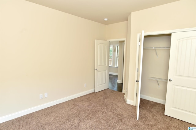 unfurnished bedroom with a closet and carpet