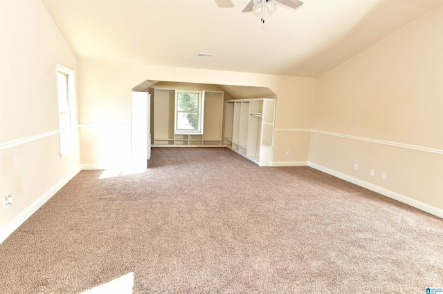 unfurnished room featuring vaulted ceiling, ceiling fan, and carpet floors