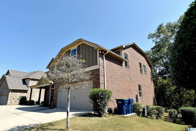 view of side of home featuring a garage and a yard