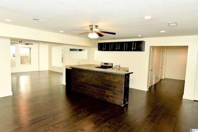 kitchen with a breakfast bar area, sink, and dark hardwood / wood-style flooring