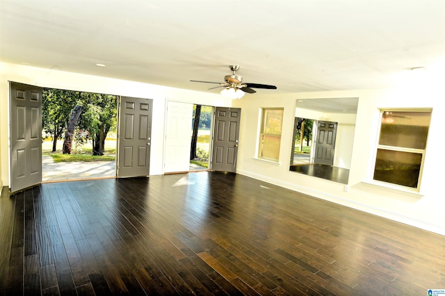 spare room with dark hardwood / wood-style flooring and ceiling fan