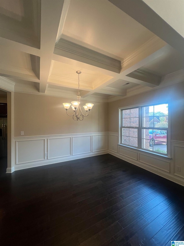 empty room featuring ornamental molding, dark hardwood / wood-style floors, coffered ceiling, beamed ceiling, and a chandelier