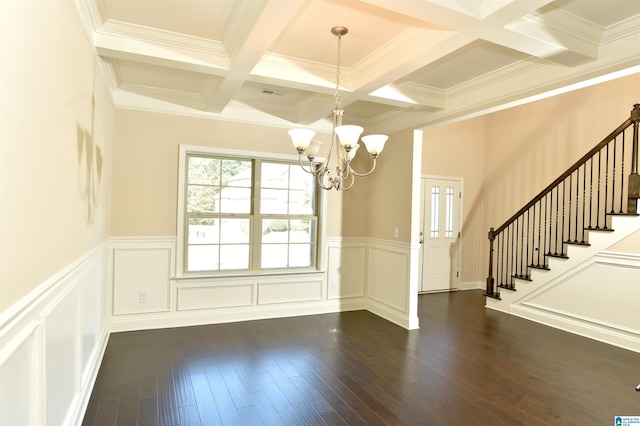 unfurnished dining area featuring dark hardwood / wood-style flooring, an inviting chandelier, and crown molding