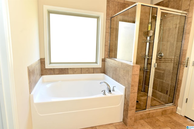 bathroom featuring separate shower and tub