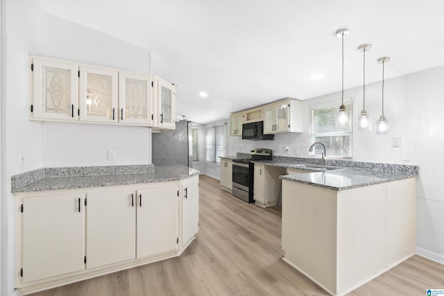 kitchen featuring light wood-type flooring, stainless steel electric range oven, stone countertops, and white cabinetry