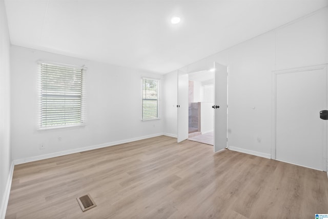 unfurnished room with light hardwood / wood-style flooring