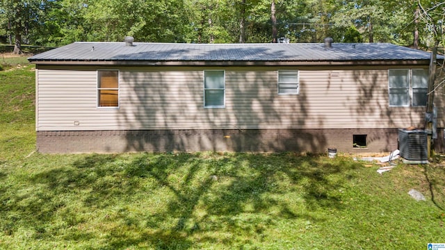 view of home's exterior with a lawn and cooling unit