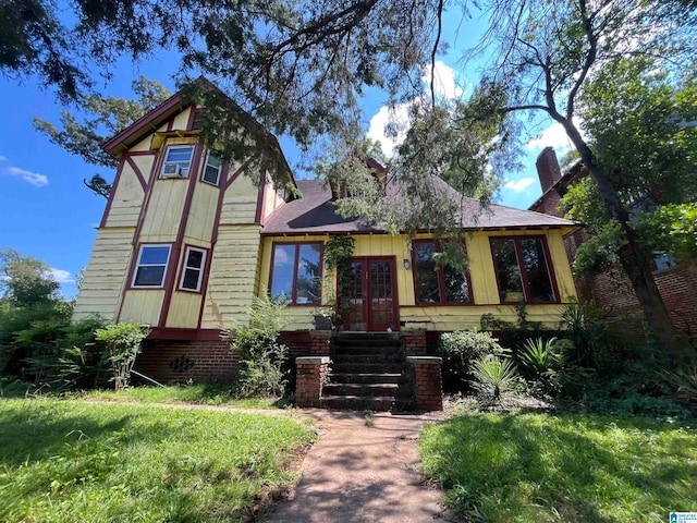 view of front of house featuring french doors and a front lawn