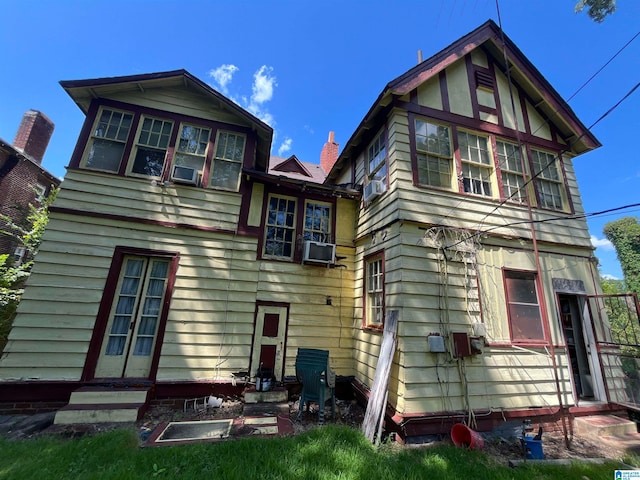 rear view of house with cooling unit