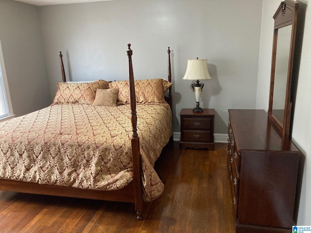 bedroom with dark hardwood / wood-style flooring