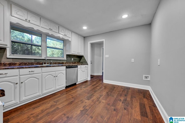 kitchen with sink, dark hardwood / wood-style flooring, stainless steel dishwasher, and white cabinetry