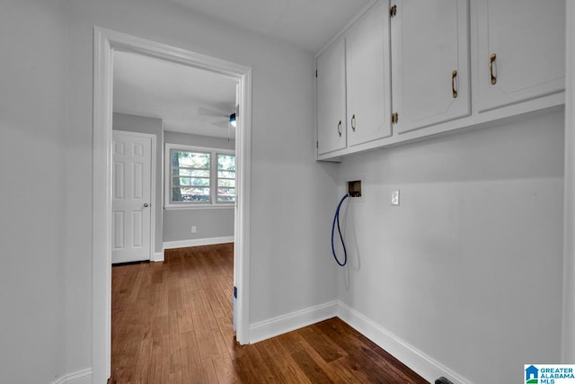 clothes washing area with hookup for a washing machine, ceiling fan, dark wood-type flooring, and cabinets