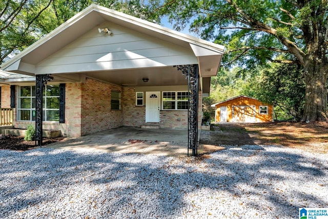 view of front of property with a shed and a garage