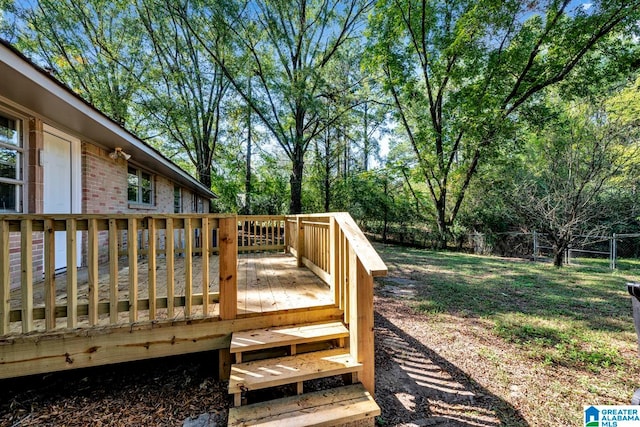 wooden terrace featuring a lawn