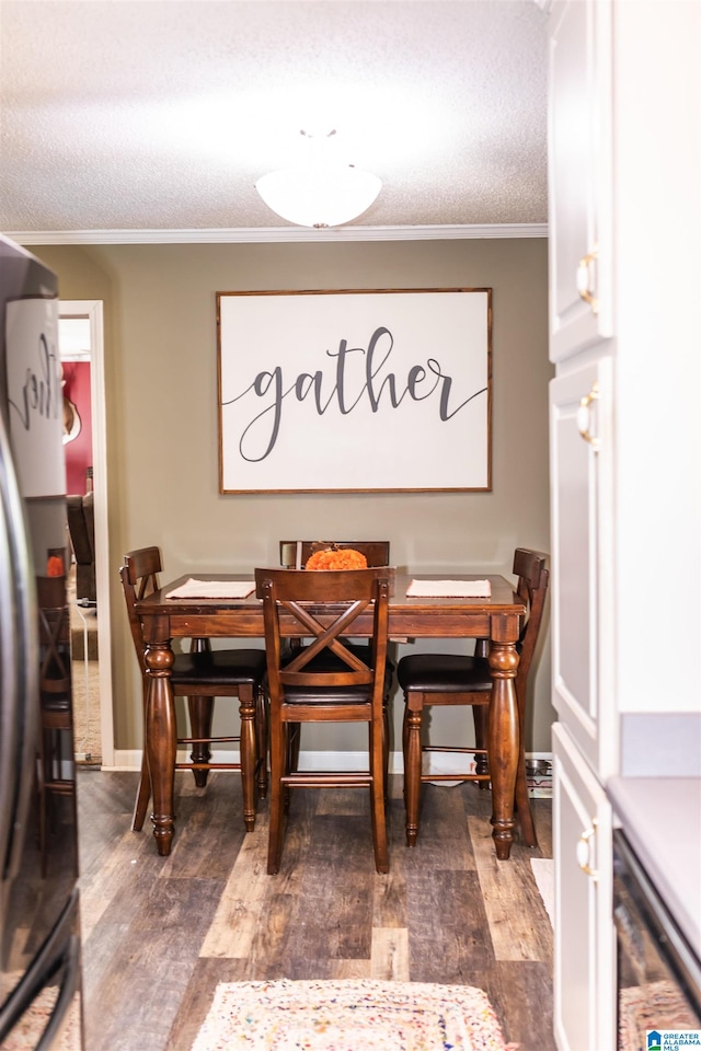 dining space with ornamental molding, a textured ceiling, and dark hardwood / wood-style flooring