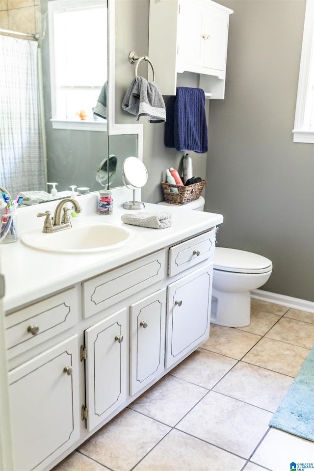 bathroom featuring vanity, tile patterned flooring, and toilet