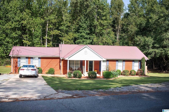 ranch-style home featuring a garage and a front lawn