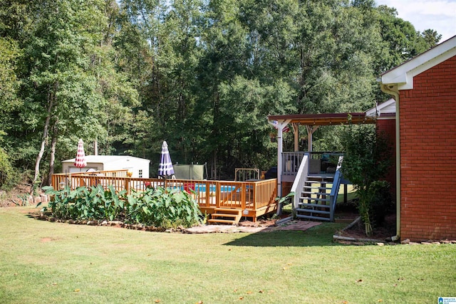 view of playground featuring a deck and a yard