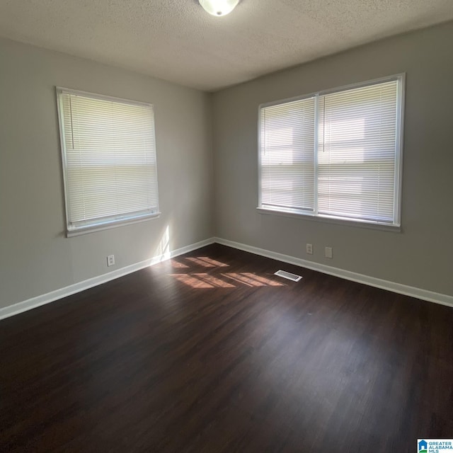 1121 Skyline Dr, Birmingham, AL 35214 - empty room with dark wood-style floors, baseboards, and a textured ceiling