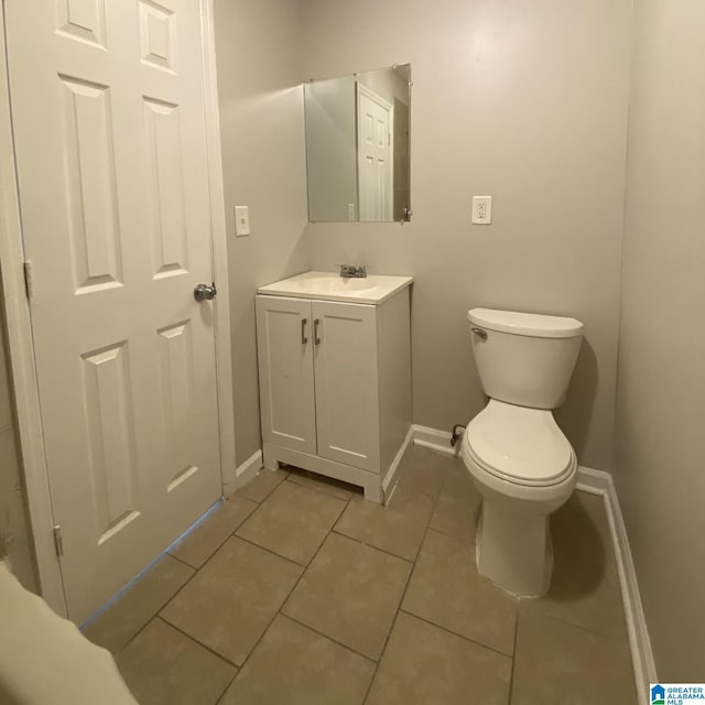 1121 Skyline Dr, Birmingham, AL 35214 - bathroom with tile patterned flooring, vanity, baseboards, and toilet