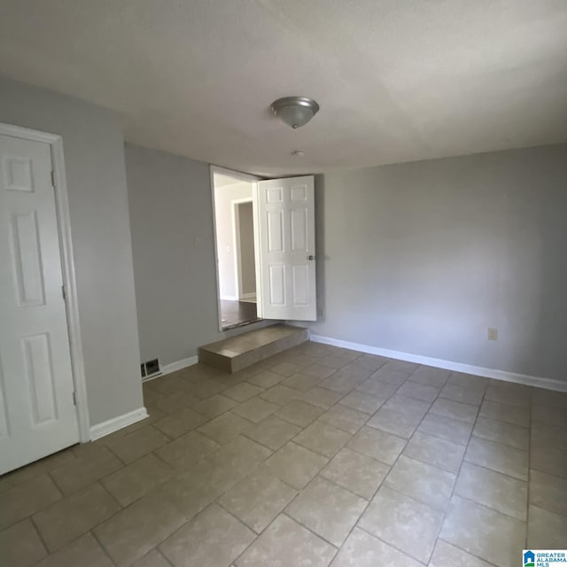 1121 Skyline Dr, Birmingham, AL 35214 - unfurnished room featuring light tile patterned floors, visible vents, and baseboards