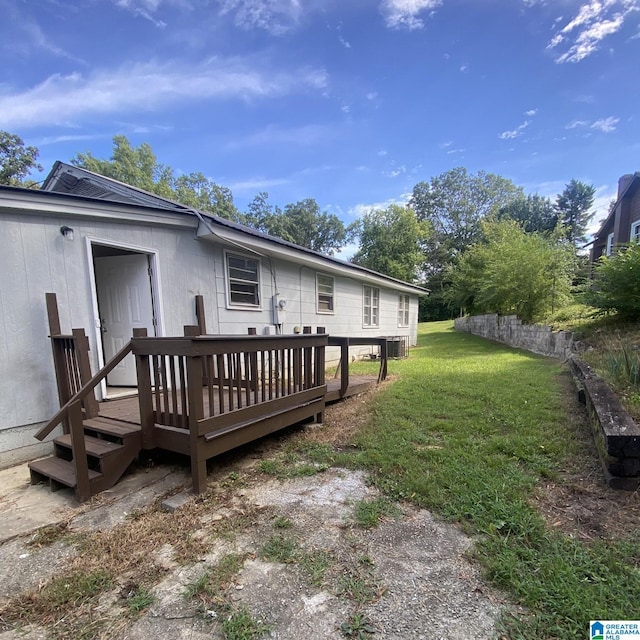 1121 Skyline Dr, Birmingham, AL 35214 - back of property with a yard, a wooden deck, and central AC unit