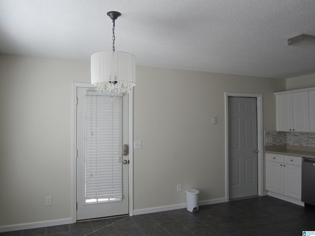 interior space featuring a chandelier and a textured ceiling