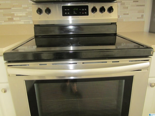 details with stainless steel electric stove and tasteful backsplash